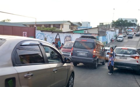 Los alumnos caminan en medio del caos vehicular que se forma frente a la escuela Esteban Cordero.