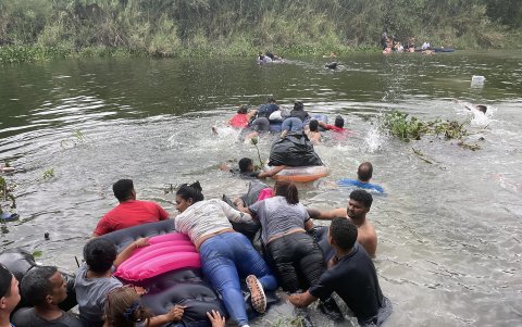 Un grupo de migrantes intentan cruzar el Río Bravo con un inflable hoy 24 de abril  de 2023, en la ciudad de Matamoros en Tamaulipas (México).