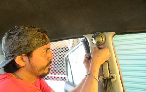 Seguridad. Experto instala una cámara de seguridad en un taxi.