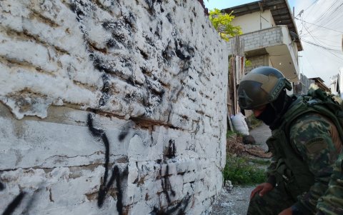 Militares trabajando en la limpieza de una de las paredes marcadas por la banda delictiva.