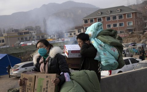 Los residentes llevan ayuda después del terremoto, durante una gira de prensa en Dahejia, en la provincia de Gansu, China, el 20 de diciembre de 2023.