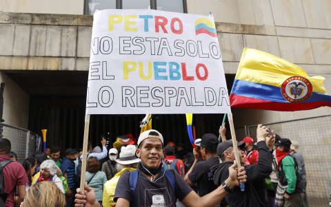 Uno de los manifestantes que participaron en una movilización popular en apoyo al presidente de Colombia, Gustavo Petro, en Bogotá, exhibe un cartel.