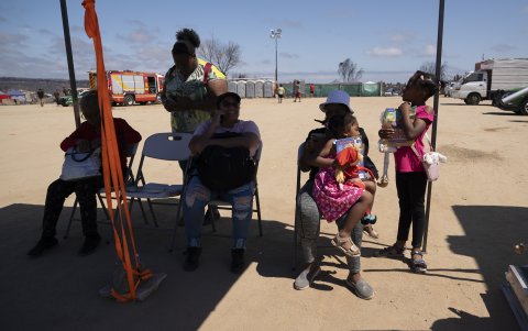 Migrantes acuden al puesto instalado por la Organización Internacional para las Migraciones (OIM)el 21 de febrero de 2024, en el sector de Pompeya en Quilpué (Chile), en busca de ayuda.