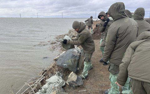 Varias personas trabajan en la colocación de muros, tras las inundaciones que azotan desde hace varias semanas Kazajistán.