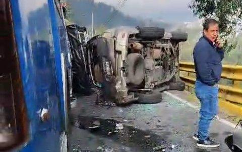 Uno de los autos quedó volcado de costado, al lado del bus, sobre la autopista al valle.