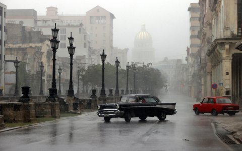 Automóviles transitan por una calle durante las fuertes lluvias debido al paso del huracán Rafael, este miércoles, en La Habana (Cuba).