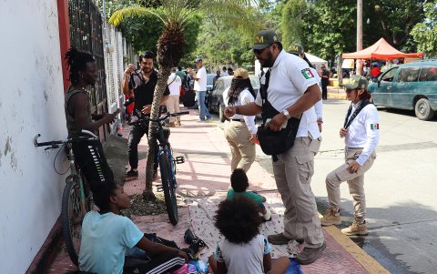 Personal del Instituto Nacional de Migración (INM) habla con un grupo de migrantes este miércoles, en el municipio de Escuintla en el estado de Chiapas (México).