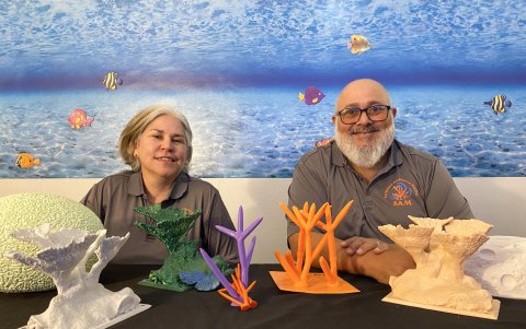 La bióloga marina Francés Candelas y el presidente y cofundador de la Sociedad Ambiente Marino (SAM) de Puerto Rico, Samuel Suleiman, junto a unos corales creados con Ácido poliláctico.