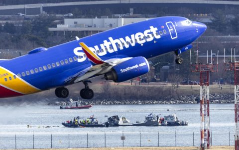 Un vuelo de Southwest Airlines despega del Aeropuerto Nacional Ronald Reagan de Washington frente a los restos de un avión comercial que chocó con un helicóptero militar.