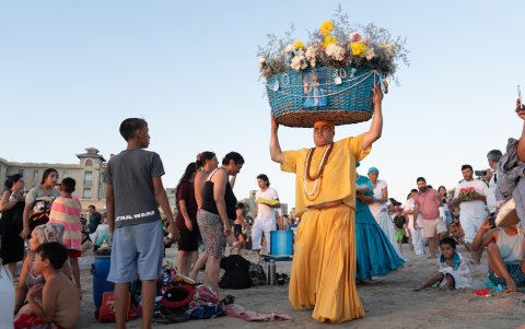 Un hombre con flores rinde tributo a la