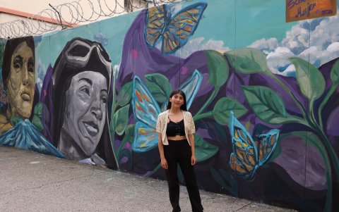 La muralista Jennifer Álvarez Cobos junto a su obra 