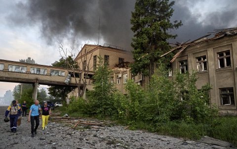 La gente local camina cerca del lugar de un ataque con drones en Járkov, al noreste de Ucrania, el 4 de junio de 2025, en medio de la invasión rusa.