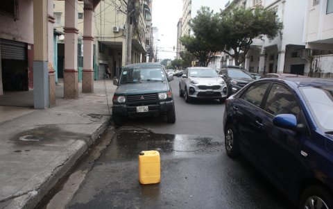 En varias zonas del centro de Guayaquil, los ‘cuidadores’ de carros utilizan envases plásticos para separar los espacios en la vía pública. La actividad sigue sin control.