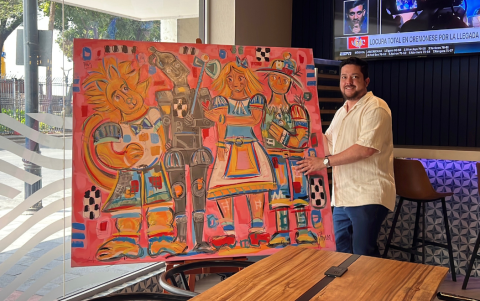 Insua muestra una de sus obras sobre cuentos infantiles expuestas en el hotel Ibis en el centro de Guayaquil.