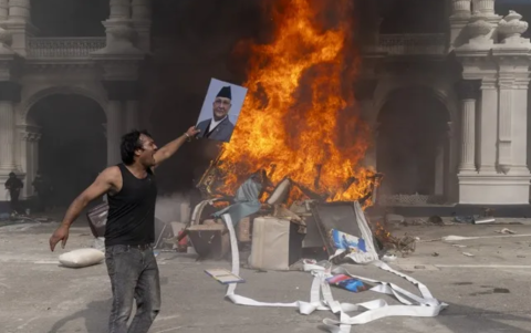 Un manifestante se prepara para quemar una imagen del dimitido primer ministro K.P. Sharma Oli mientras asalta el palacio Singha Durbar.