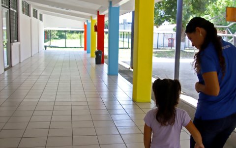 Una mujer acompañada de una menor camina por el corredor de una estancia infantil este sábado, en el municipio de Tapachula en Chiapas (México).