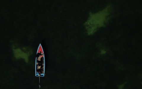 Fotografía aérea, tomada el pasado 12 de septiembre, de una embarcación en la isla Sicuya, al navegar en medio de algas y agua turbia, en el lago Titicaca (Bolivia).
