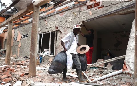 Hombre camina junto a los estragos de la explosión.