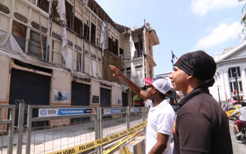 Trabajadores del sector de la Casa Tola observan el riesgo de colapso de la vivienda hacia los negocios aledaños.