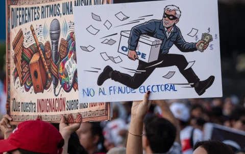 Personas sostienen carteles en la “Gran Marcha Defendamos la democracia”, en Lima (Perú).