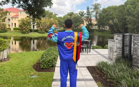 Eduardo Jara posa luciendo el uniforme oficial de voluntariado de la FIFA, vistiendo además los colores de Ecuador.