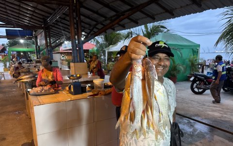 Bolívar Chávez, comerciante de mariscos en Playita Mía, muestra una sarta de pescado