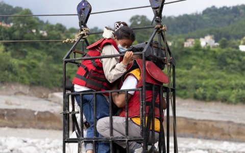 Personas cruzan un puente colgante provisional conocido localmente como Twin Cross en Nepal, el 4 de septiembre de 2026.