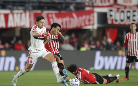 Tiago Palacios (c) de Estudiantes disputa el balón con Saúl Ñíguez de Flamengo.