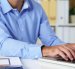 Cropped image of businessman working on laptop