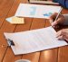 Close-up image of entrepreneur checking document before signing