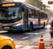 Un bus de transporte público circula por una intersección urbana mientras agentes realizan controles de tránsito para prevenir infracciones y siniestros viales.