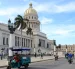 Un triciclo y varias motocicletas eléctricas circulan frente al Capitolio este martes 14 de abril de 2026,en La Habana (Cuba).