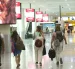 Personal aeroportuario y viajeros se movilizan hacia la terminal aérea con documentación de vuelo en medio de las restricciones nocturnas.