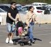 Una pareja al caminar con un par de perros, llevados en un choche de bebés, durante feria ‘Expo Mascotas & Animales’, en Santiago de Chile, una ciudad con baja tasa de natalidad.