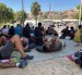Varios migrantes congregados en los alrededores del Embolsamiento Loma Colmenar, uno de los puntos de acogida, este sábado 22 de agosto en Ceuta.