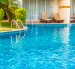 Empty Umbrella and chair around swimming pool in hotel resort