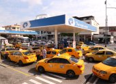 Un grupo de taxis hacen fila para poner combustible en una gasolinera en Guayaquil.