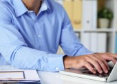 Cropped image of businessman working on laptop