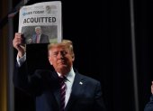US President Donald Trump holds up a newspaper that displays a headline "Aquitted"  as he arrives to speak at the 68th annual National Prayer Breakfast on February 6, 2020 in Washington,DC. President Donald Trump said Thursday that he suffered a "terrible ordeal" during his impeachment. In his first public comments since being acquitted by the Senate of abuse of office, he said he had been "put through a terrible ordeal by some very dishonest and corrupt people." "They have done everything possible to destroy us and by so doing very badly hurt our nation," he said at a televised prayer breakfast with a Who"s Who of Washington power brokers.
 / AFP / Nicholas Kamm

 US-POLITICS-PRAYER-TRUMP