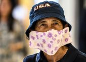 A shopper, wearing a protective facemask amid fears over the spread of the COVID-19 coronavirus, walks in a store in Bangkok on February 17, 2020. (Photo by Mladen ANTONOV / AFP)