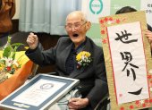 (FILES) In this Japan Pool picture received via Jiji Press on February 12, 2020, 112-year-old Japanese man Chitetsu Watanabe poses next to calligraphy reading in Japanese "World Number One" after he was awarded as the world"s oldest living male in Joetsu, Niigata prefecture. - A Japanese man recently named the world"s oldest living male has died aged 112, a local official said on February 25, 2020. (Photo by JAPAN POOL / JIJI PRESS / AFP) / Japan OUT