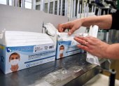 An employee packs repiratory protective face masks on an assembly line at the Valmy protective mask manufacturer plant in Mably, central France, on February 28, 2020, amid the spread of COVID-19, the novel coronavirus. The spread of the new coronavirus to Europe has boosted the activity of Valmy, one of the French protective face mask manufacturers, with the number of employees in the production plant and warehouse rising from around 20 to 60 in the past month. / AFP / PHILIPPE DESMAZES

 FRANCE-HEALTH-VIRUS-MANUFACTURING-COMPANY