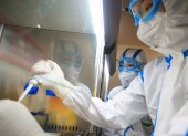 This photo taken on February 19, 2020 shows laboratory technicians testing samples of virus at a laboratory in Hengyang in China"s central Henan province. - The death toll from the COVID-19 coronavirus epidemic jumped to 2,112 in China on February 20 after 108 more people died in Hubei province, the hard-hit epicentre of the outbreak. (Photo by STR / AFP) / China OUT