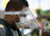 MERRICK, NEW YORK - MARCH 31: A Pat"s Farms grocery store worker wears a mask and plastic visor on March 31, 2020 in Merrick, New York. The World Health Organization declared coronavirus (COVID-19) a global pandemic on March 11.   Al Bello/Getty Images/AFP

== FOR NEWSPAPERS, INTERNET, TELCOS & TELEVISION USE ONLY ==

 US-CORONAVIRUS-PANDEMIC-CAUSES-CLIMATE-OF-ANXIETY-AND-CHANGING-R