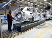 Employees work on the production line at the Volvo car factory in Torslanda, Gothenburg, Sweden on April 17,2020. - Volvo Cars has started up the production at the factory in Torslanda again after a stand still since March 26 due to the novel coronavirus, Covid-19 pandemic. (Photo by Adam IHSE / TT NEWS AGENCY / AFP) / Sweden OUT