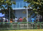 Residents queue for their food at Tuas South foreign workers dormitory that has been placed under government restriction as preventive measure against the spread of the COVID-19 coronavirus in Singapore on April 19, 2020. - Singapore imposed a mandatory stay-home order for migrant workers including in the construction sector for 14 days effective on April 20 due to coronavirus pandemic. (Photo by Roslan RAHMAN / AFP)