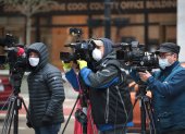 CHICAGO, ILLINOIS - APRIL 30: Journalist wearing masks document a protest where demonstrators were calling on the governor to suspend rent and mortgage payments to help those who have lost their income due to the coronavirus on April 30, 2020 in Chicago, Illinois. On May 1, the state of Illinois will begin requiring everyone to wear a face mask in public when social distancing is not possible to prevent the spread of the coronavirus COVID-19. The state is currently on a "stay at home" mandated by the governor until May 30.   Scott Olson/Getty Images/AFP