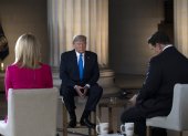 US President Donald Trump gestures as he speaks during a Fox News virtual town hall "America Together: Returning to Work," event, with anchors Bret Baier (R) and Martha MacCallum (L), from the Lincoln Memorial in Washington, DC on May 3, 2020. - Trump will answer questions submitted by viewers on Twitter, Facebook and Instagram. (Photo by JIM WATSON / AFP)