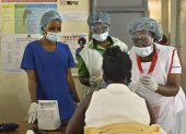 Volunteer nurse, Anita Thumbi (L), who is also an elected Member of County Assembly (MCA) in the Nairobi County Government, tends to patients with other nursing staff at a facility used to train the public on infection prevention and management at a local health centre in Waithaka, a Nairobi suburb on May 12, 2020, on International Nurses Day. - Anita Thumbi, a nurse by training, chose to forego the lofty perch of elective office opting to return to her grassroots as a volunteer nurse to join the frontlines in the fight against the COVID-19 coronavirus after the discovery of the first case of infection within Kenya two-months ago at a time of apprehension about Kenya"s ability to cope with the rapidly spreading pandemic. (Photo by TONY KARUMBA / AFP)