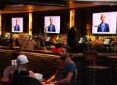 Former US President Barack Obama is seen on television screens as he speaks during the third day of the Democratic National Convention, being held virtually amid the novel coronavirus pandemic, at The Abbey bar and restaurant in West Hollywood, California, August 19, 2020. (Photo by Robyn Beck / AFP)